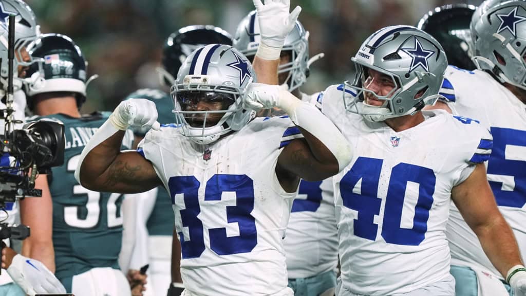Javonte Williams celebrates beside Hunter Luepke during a Dallas Cowboys game, giving fantasy football managers two names to watch in the backfield.