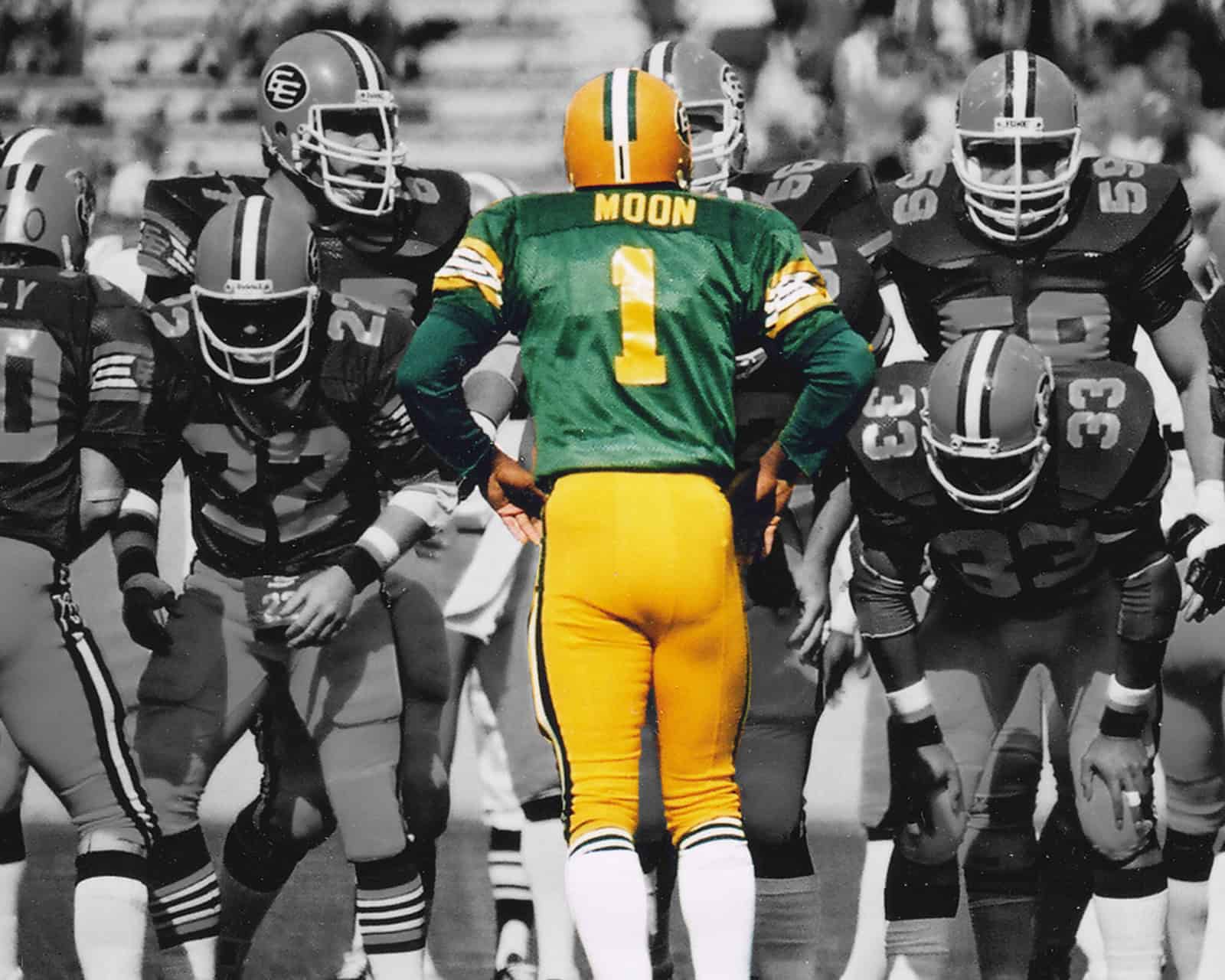 Warren Moon stands at the line of scrimmage in his Edmonton uniform during a CFL game.