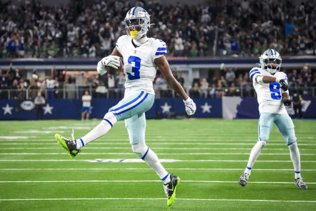 Cowboys wide receiver George Pickens celebrates with the football after a touchdown as KaVontae Turpin follows behind him.