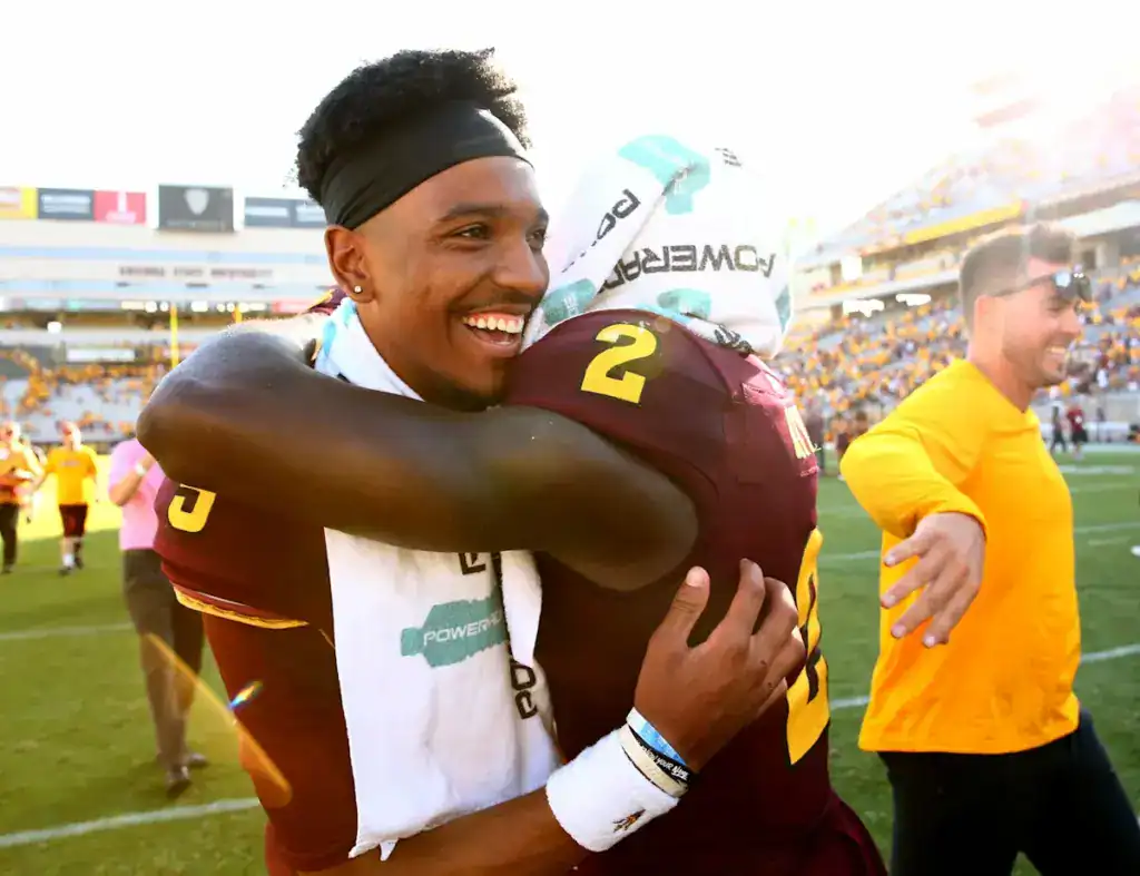 Brandon Aiyuk to Dallas Sounds Good Until The Headache Takes Over Jayden Daniels smiles while embracing Arizona State teammate Brandon Aiyuk following a Sun Devils football game.