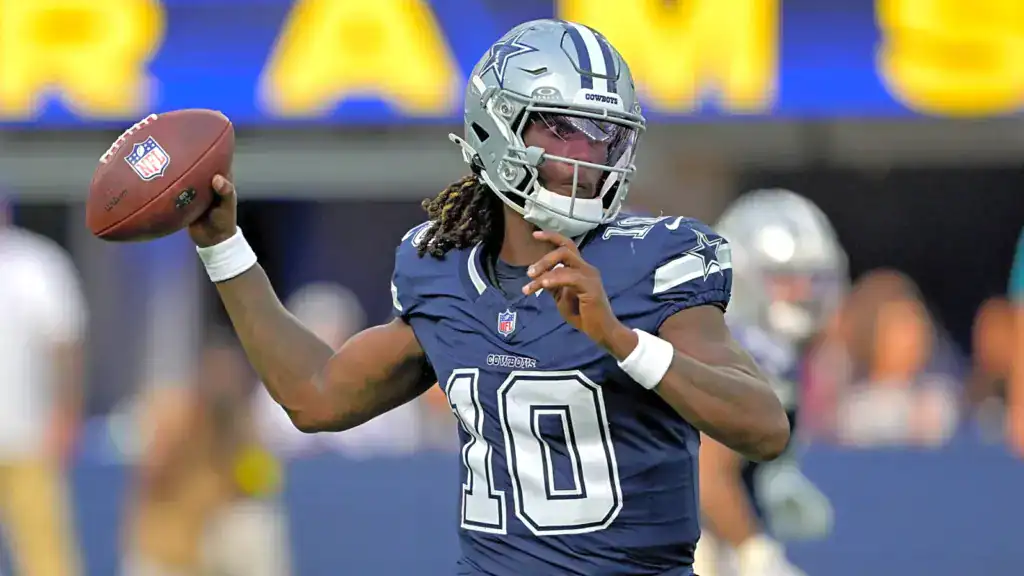 Will Cowboys Nostalgia Bring Shedeur Sanders to Dallas? Joe Milton III throws a pass during Dallas Cowboys warmups in his navy No. 10 jersey.