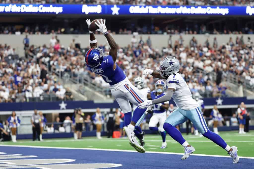 New York Giants wide reciever Malik Naber catches a pass in the end zone over a Dallas Cowboys secondary player.