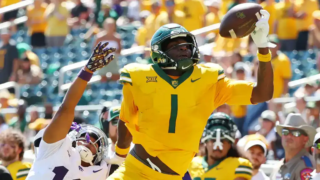 Cowboys Should Make Room for Michael Trigg in 26' Michael Trigg, wearing Baylor’s gold No. 1 uniform, reaches up to make a one-handed catch against Kansas State.