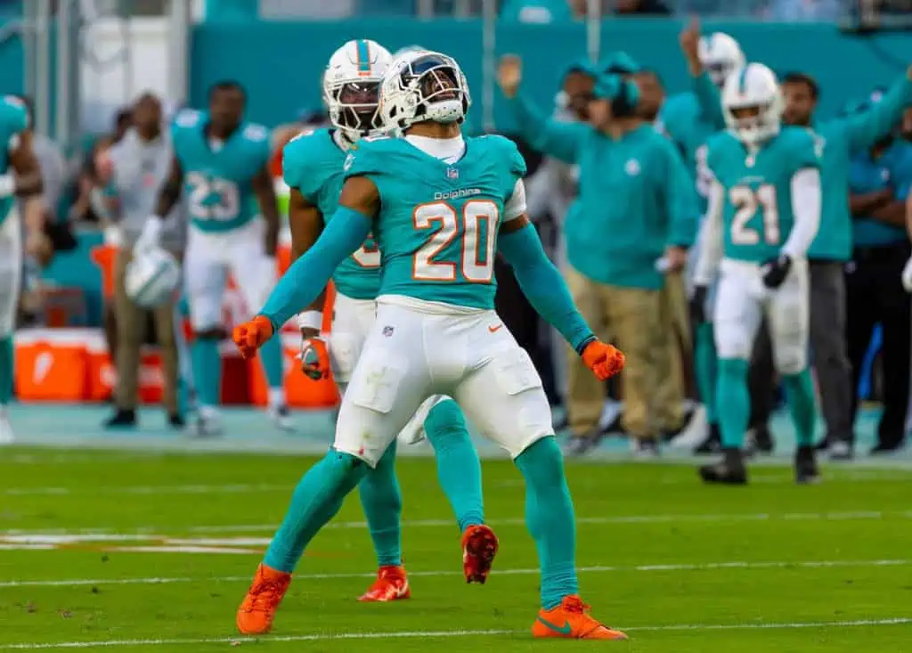 Jordyn Brooks celebrates on the field in a Miami Dolphins No. 20 uniform.