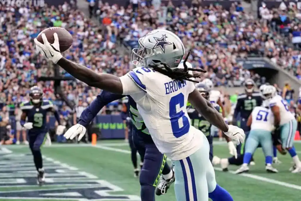 Dallas Pass Catchers Make Their Case in Preseason Game 1 Camden Brown reaches out with one hand to make a catch near the sideline against the Seattle Seahawks.