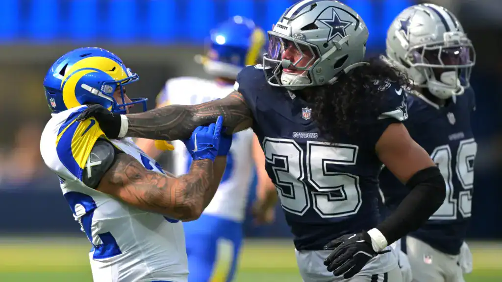 Marist Liufau battles a Los Angeles Rams blocker during game action for the Dallas Cowboys.