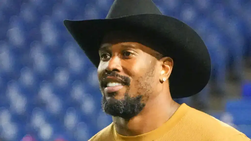Von Miller wears a black cowboy hat while attending an NFL event.