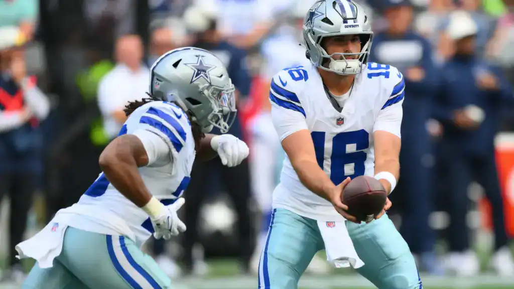 Dallas Cowboys quarterback Sam Howell hands the ball to running back Jaydon Blue during a preseason game against the Seattle Seahawks
