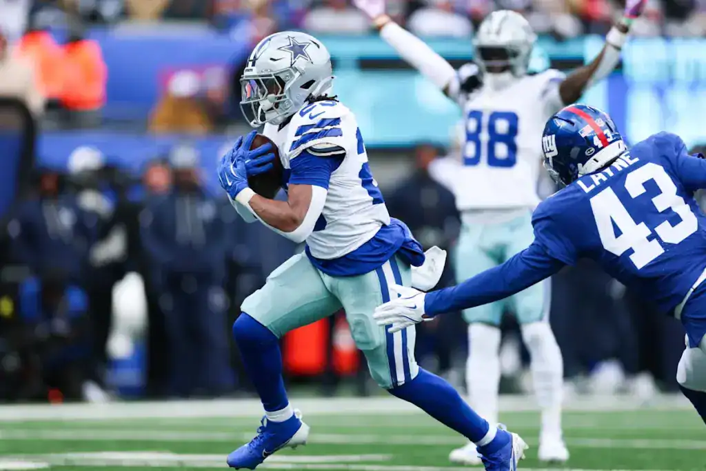 Cowboys Preseason Game 1: A Running Back Conundrum Dallas Cowboys running back Jaydon Blue runs with the football as a New York Giants defender reaches for the tackle.