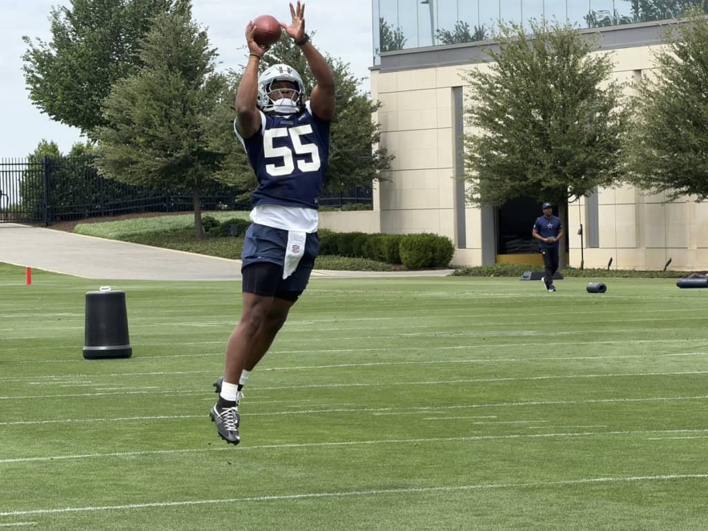 Dallas Cowboys linebacker Jaishawn Barham catches a pass during a training camp drill.