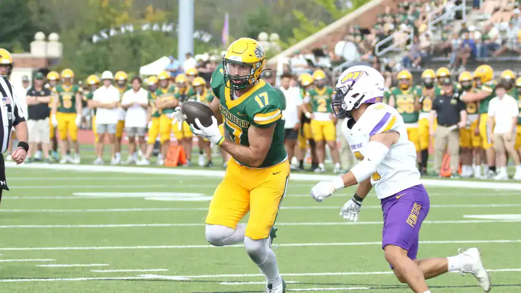 Mitch Van Vooren carries the football during a St. Norbert College game.