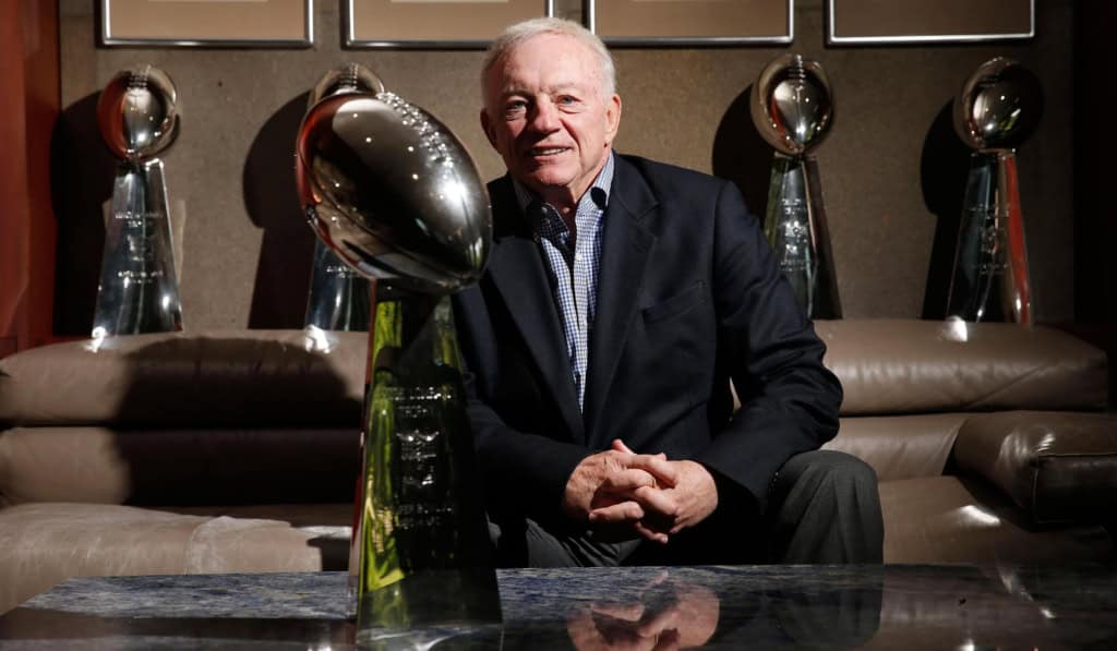 Jerry Jones sits in front of the Dallas Cowboys’ five Lombardi Trophies at team headquarters.