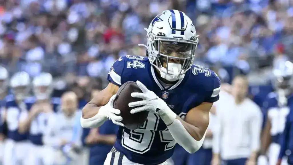 Cowboys Preseason Game 1: A Running Back Conundrum Dallas Cowboys running back Malik Davis secures the football in a navy No. 34 uniform during game action.