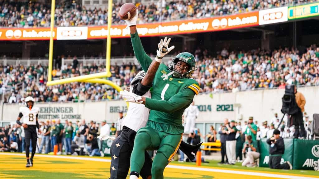Cowboys Should Make Room for Michael Trigg in 26' Michael Trigg in Baylor’s green No. 1 uniform extends for a contested catch near the end zone during a college football game.