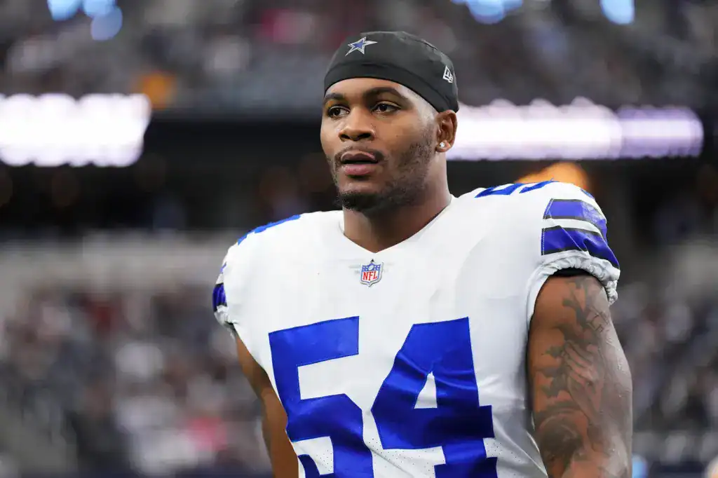 Sam Williams stands on the sideline in a white Dallas Cowboys uniform.