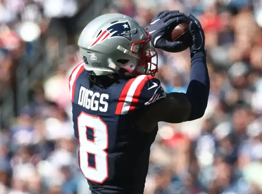 New England Patriots wide receiver Stefon Diggs makes a catch while wearing the team’s navy uniform during an NFL game.