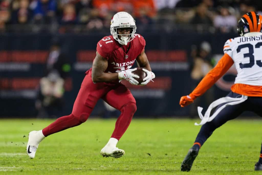 Arizona Cardinals running back Emari Demercado carries the football against the Cincinnati Bengals defense.