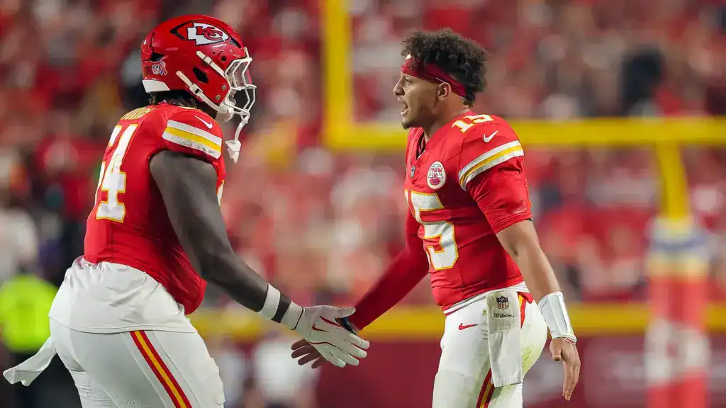 Dallas Cowboys offensive tackle Wanya Morris shakes hands with Patrick Mahomes when they were teammates in Kansas City. Morris has been added to the Cowboys practice squad.