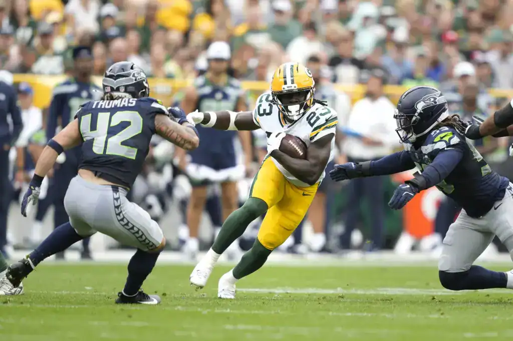 Dallas Cowboys Israel Abanikanda runs between two Seahawks defenders as a member of the Green Bay Packers is one of the latest names to be added to the Cowboys practice squad.