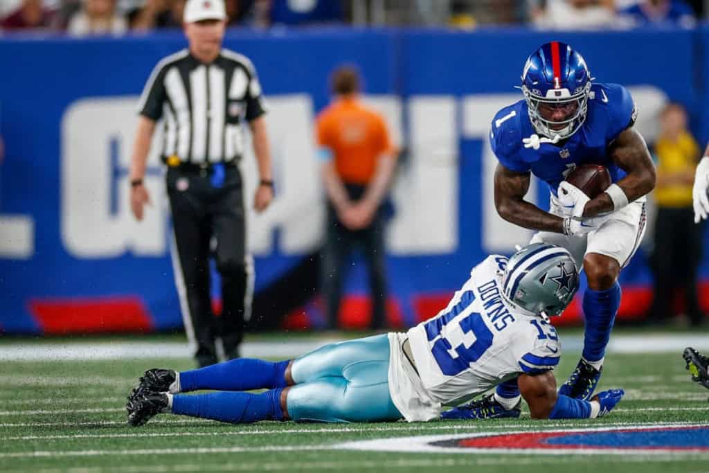Cowboys 26' Green Dot: Caleb Downs or Jaishawn Barham? Dallas Cowboys safety Caleb Downs making a tackle on a New York Giants player.