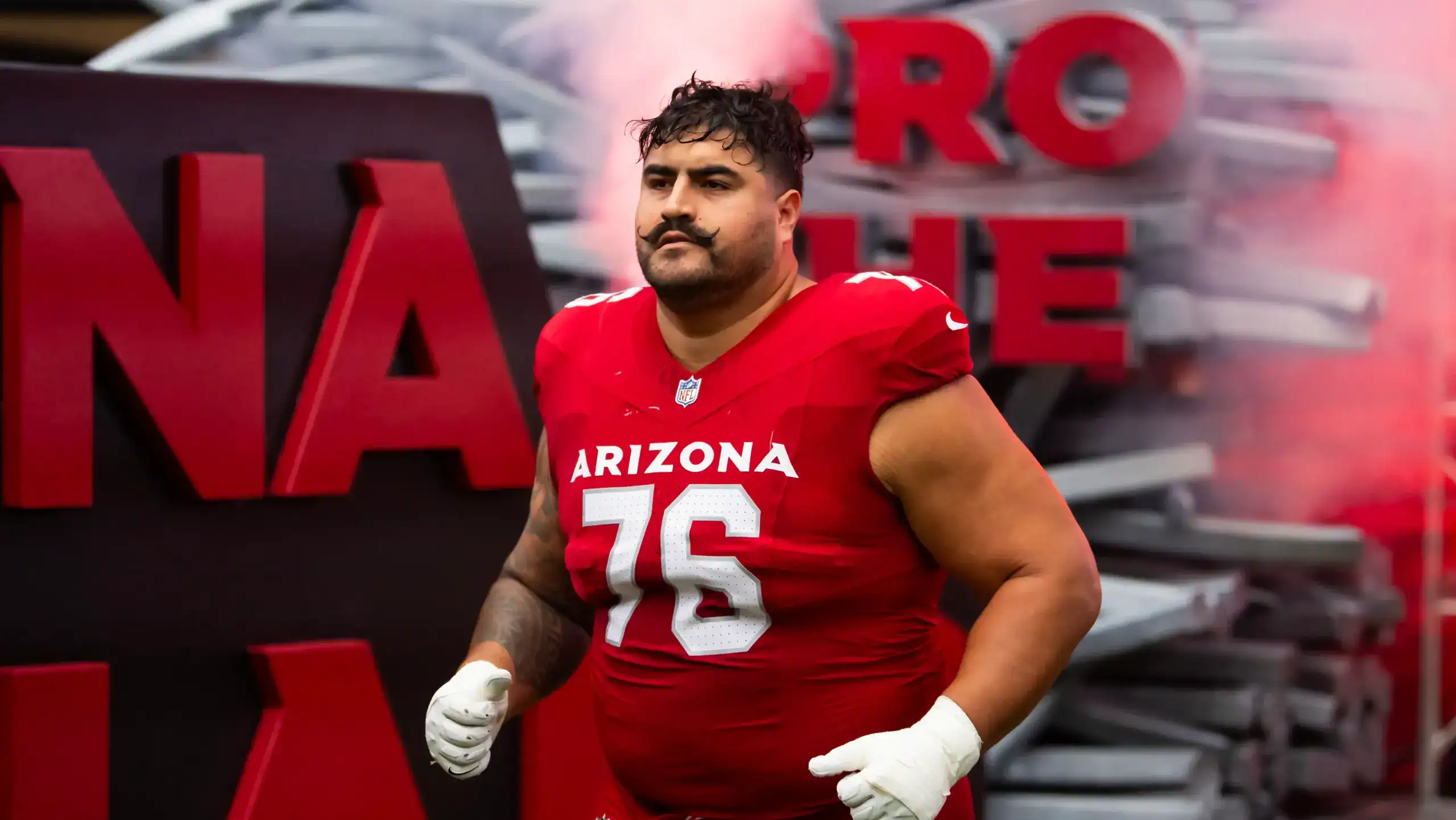 Arizona Cardinals offensive guard Will Hernandez runs onto the field before a game.