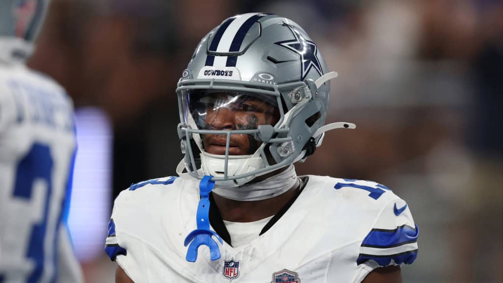 Dallas Cowboys safety Caleb Downs in a white Cowboys uniform getting ready for another play.