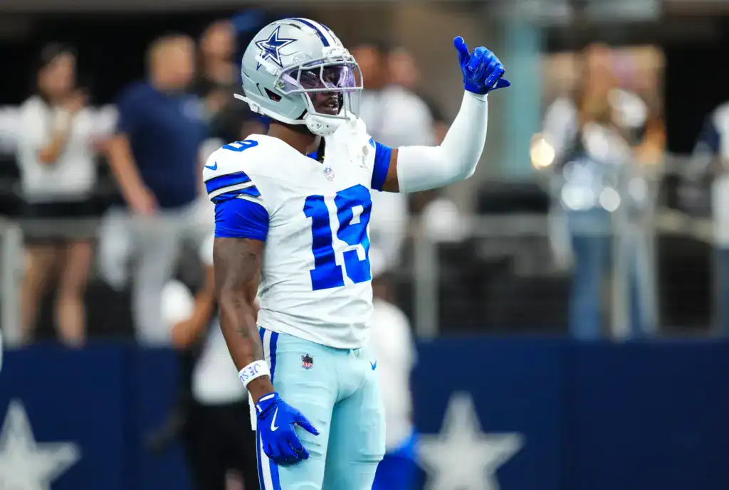 Dallas Cowboys wide receiver Ryan Flourney standing on the football field holding his left arm up giving a thumbs up. 