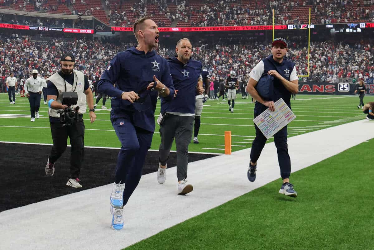 Dallas Cowboys head coach Brian Schottenheimer celebrates as he leaves the field following a game against Houston.