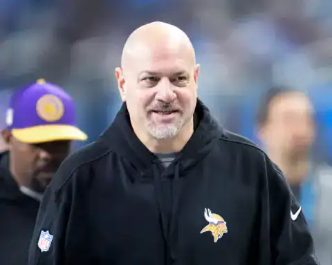 Vikings assistant Mike Pettine standing on the sidelines of a game.