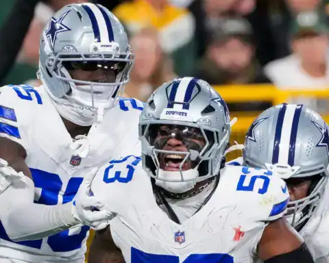 Cowboys defensive players celebrate after a Dee Winters interception.