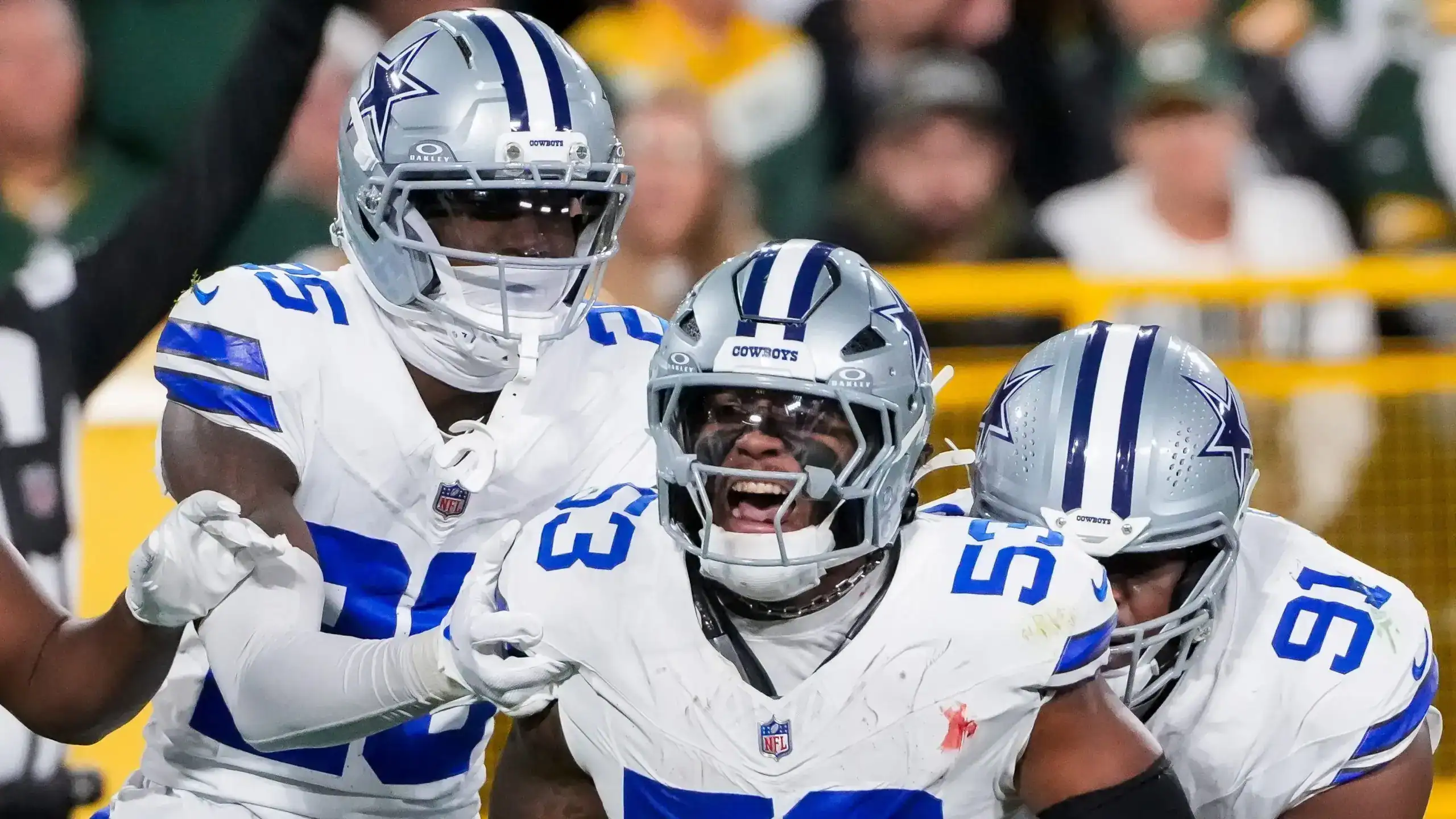 Cowboys defensive players celebrate after a Dee Winters interception.