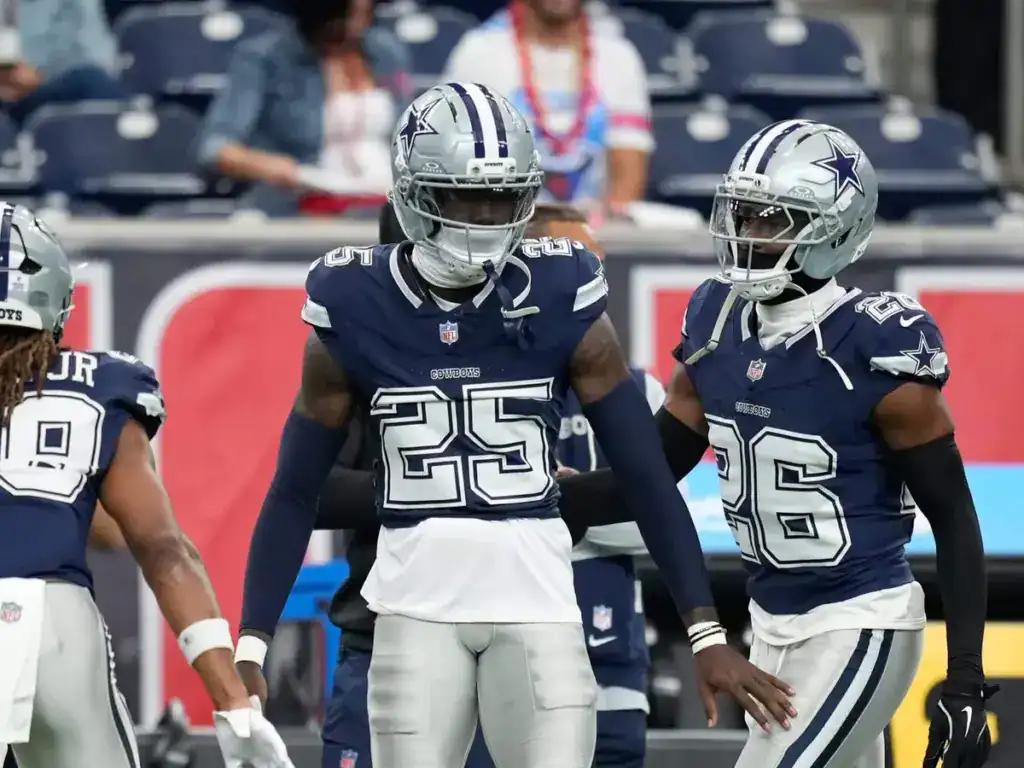 Cowboys cornerback Joey Porter Jr celebrates with fellow defensive players during a Cowboys game.