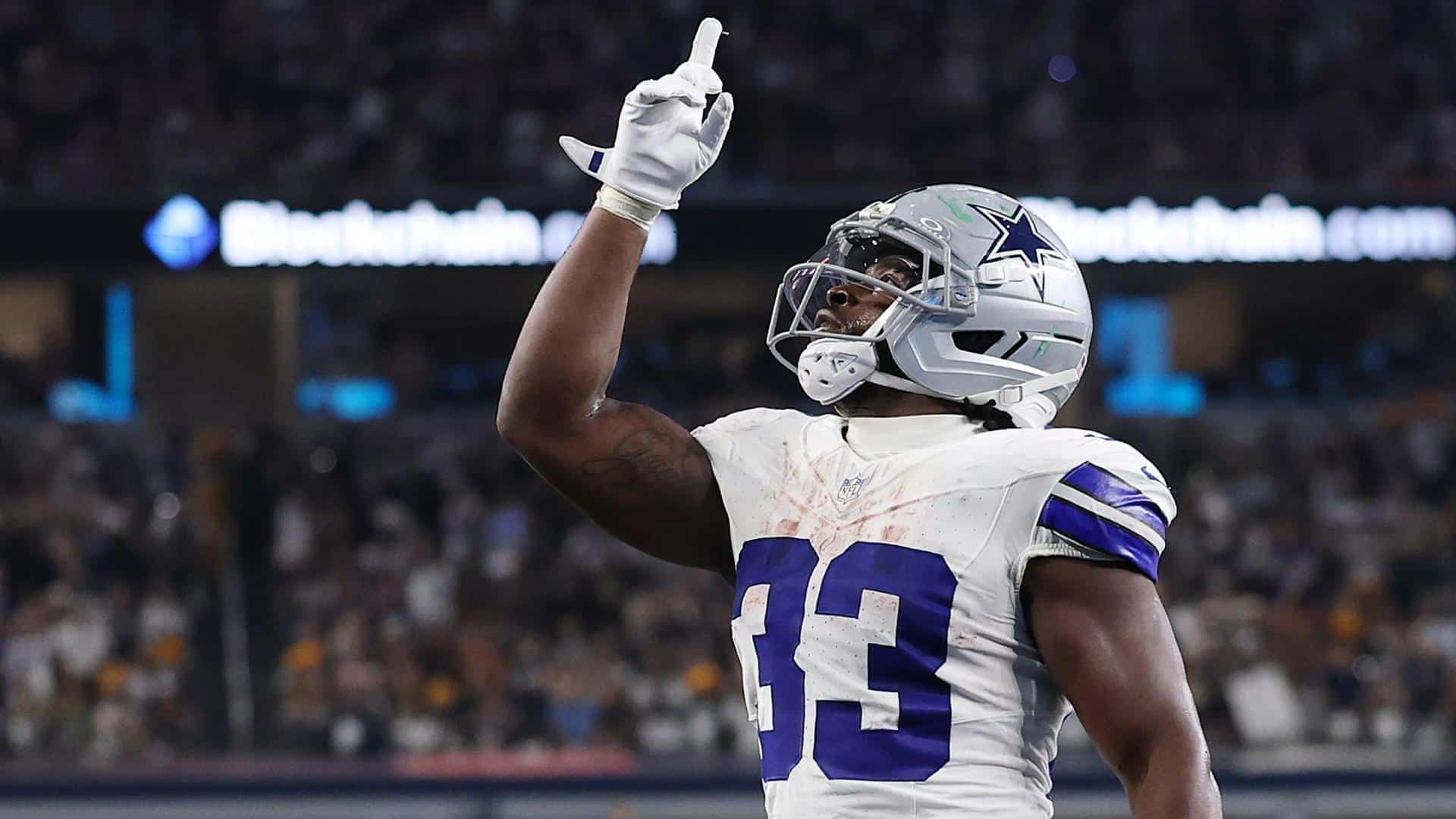 Cowboys running back Javonte Williams pointing towards the sky honoring God.