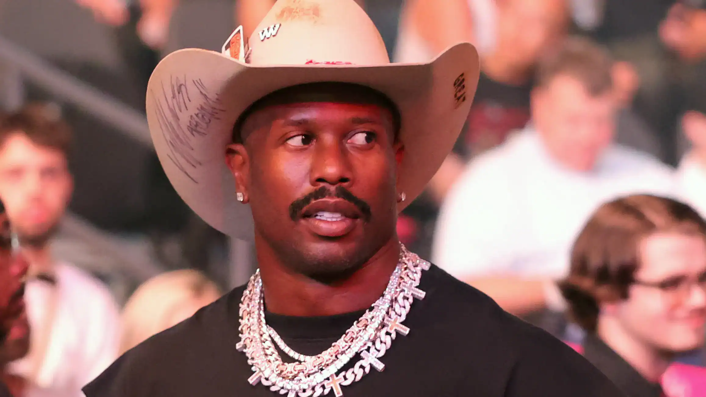 Dallas Cowboys linebacker Von Miller wearing a tan cowboy hat while attending an event.