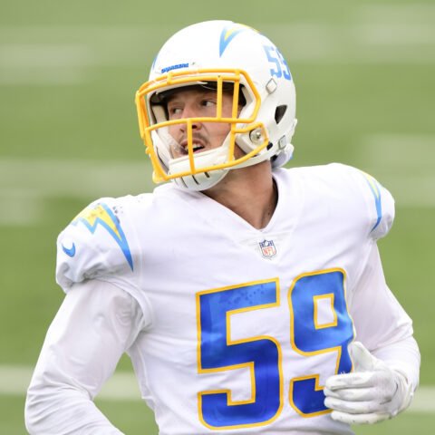 Football player wearing a white and yellow uniform with number 59 on the field.