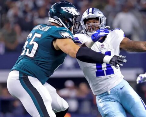 Two American football players from opposing teams engage in a fierce clash during a thrilling Week 10 game, with the ball cleverly concealed.