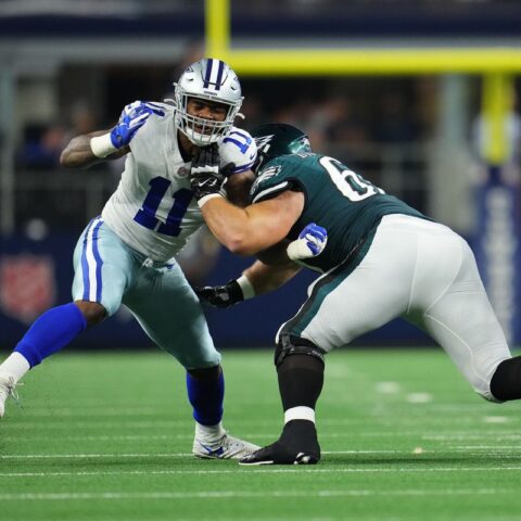 In Week 10, two football players clashed on the field—one in white and blue, representing the Cowboys, and the other in green and white for the Eagles.