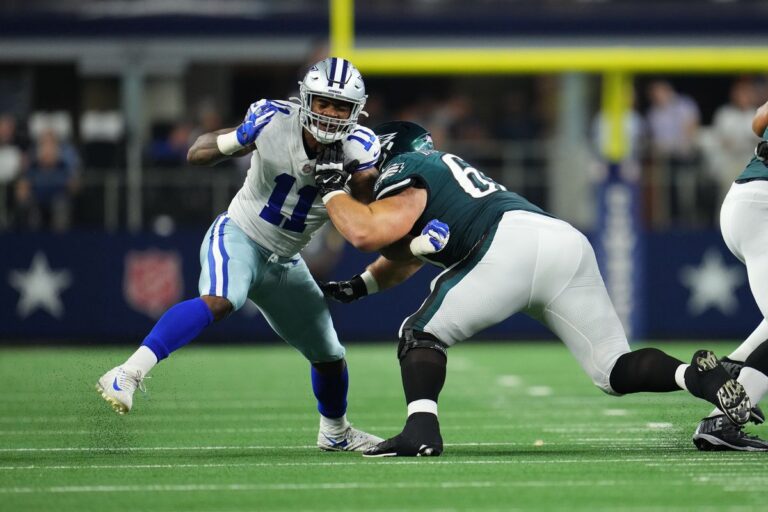 In Week 10, two football players clashed on the field—one in white and blue, representing the Cowboys, and the other in green and white for the Eagles.