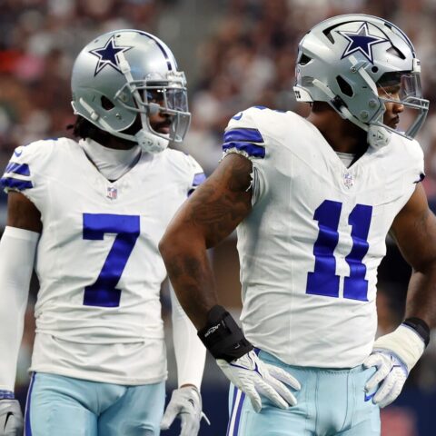 Two American football players in Dallas Cowboys uniforms stand poised on the field during a Week 12 game, showcasing the strength of the Cowboys defense.
