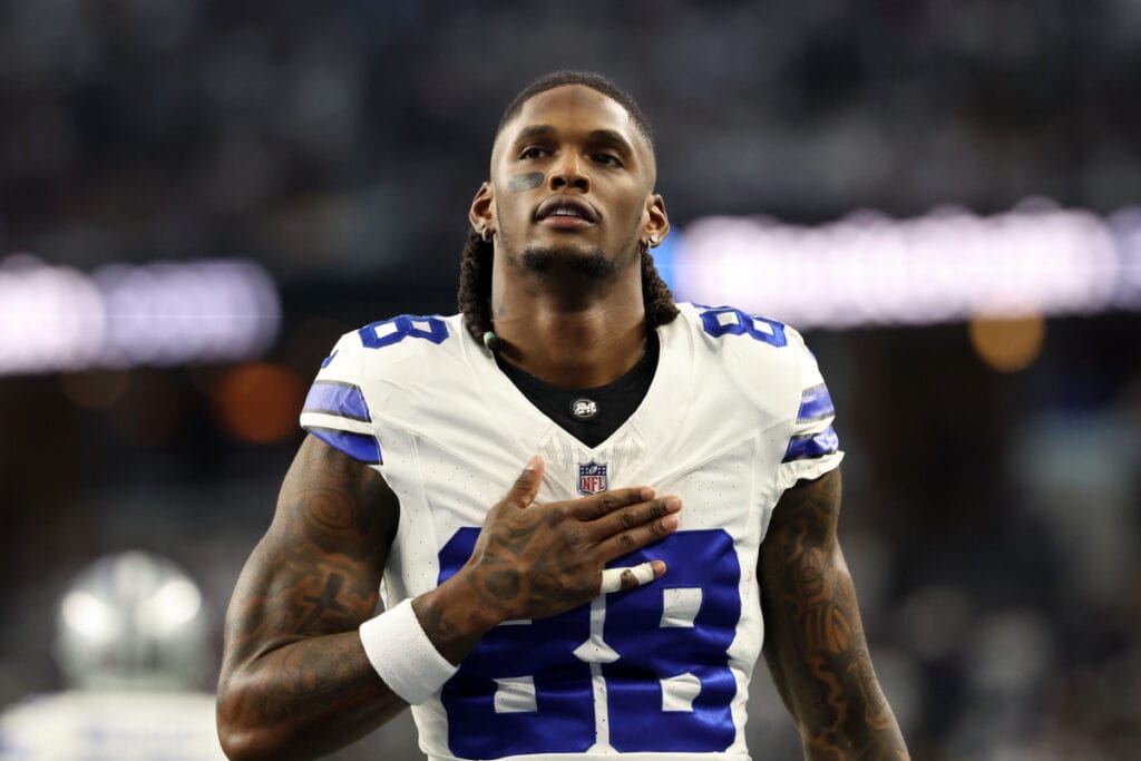 Football player wearing a white jersey with the number 88, who looks like CeeDee Lamb of the Cowboys, stands with his right hand on his chest, as in a heartfelt moment in Week 11.