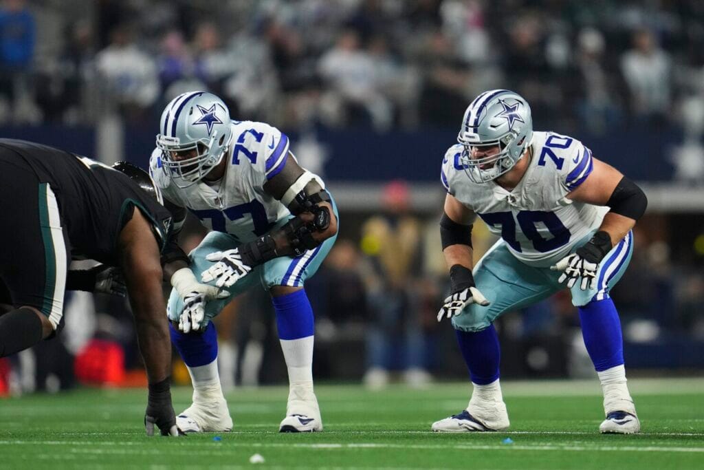 ARLINGTON, TX - DECEMBER 24: Tyron Smith #77 of the Dallas Cowboys and Zack Martin #70 get set against the Philadelphia Eagles at AT&amp;T Stadium on December 24, 2022 in Arlington, Texas. (Photo by Cooper Neill/Getty Images)
