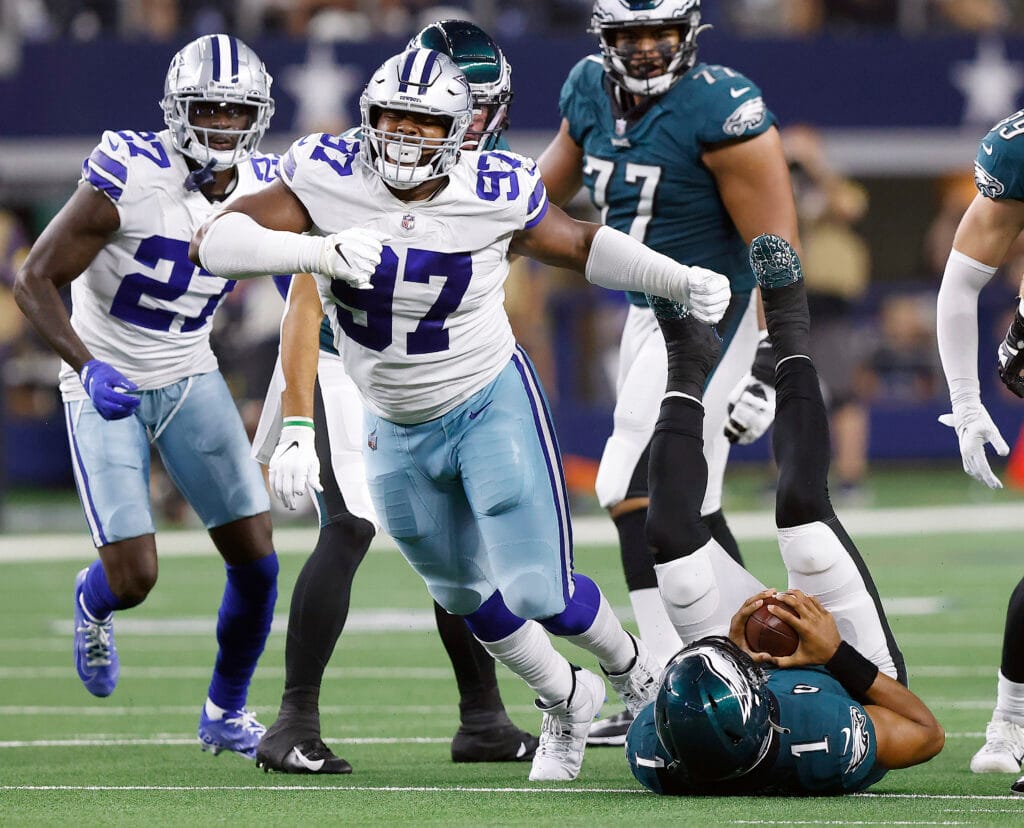 Dallas Cowboys defensive tackle Osa Odighizuwa (97) celebrates his third quarter sack of Philadelphia Eagles quarterback Jalen Hurts (1) during the second quarter at AT&amp;T Stadium in Arlington, Monday, September 27, 2021. (Tom Fox/The Dallas Morning News)
