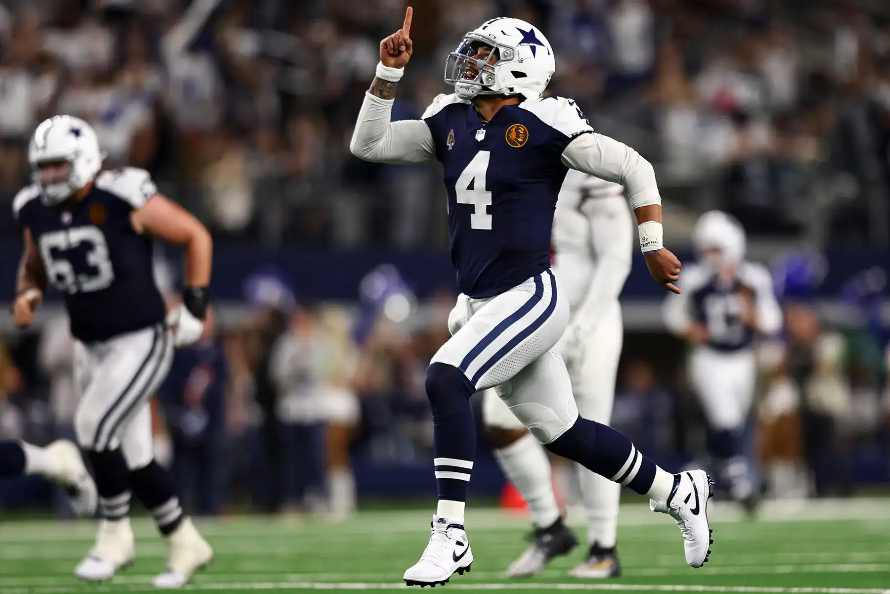 2025 Dallas Cowboys Schedule Breakdown & Forecast - 2025 Cowboys Schedule, Christmas Day, Thanksgiving Day a football player in a uniform pointing up