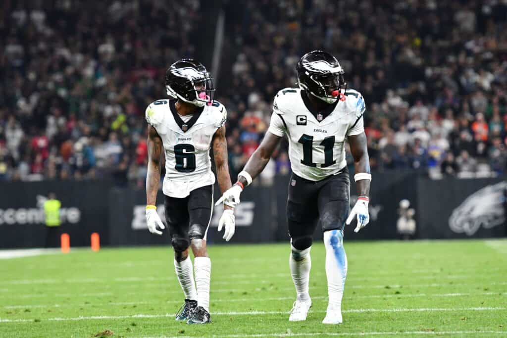 Two Philadelphia Eagles wide receivers are standing side by side. Wearing white uniforms with green pants, one of the players is has the number six and the other has number 11. Lamb & Pickens vs. Brown & Smith: Who's the NFL's Best Receiver Duo in 2025?
