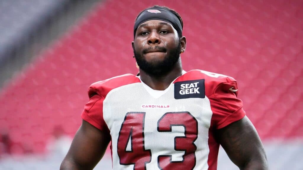 Linebacker Jesse Luketa in an Arizona Cardinals jersey standing on the practice field. Jesse Luketa and the Cowboys Superstar Connection