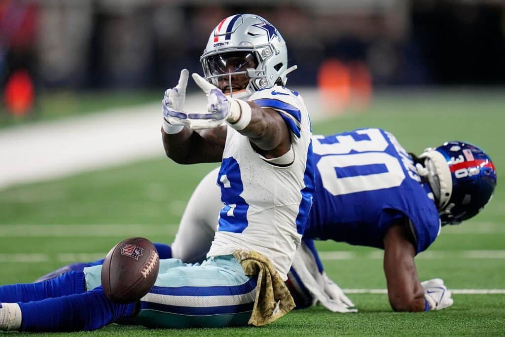 Dallas Cowboys player CeeDee Lamb celebrating after a first down catch over a New York Giant player. The NFC East's Most Dangerous Roster Belongs to the Cowboys