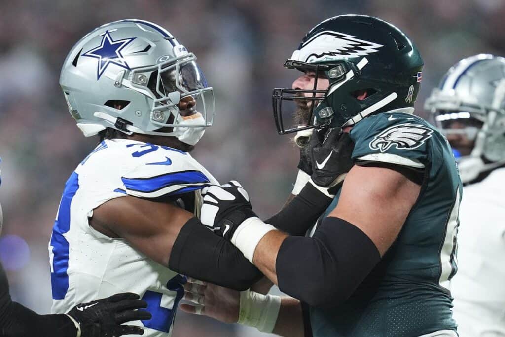 Dallas Cowboys player and Philadelphia Eagles player grappling after the play. The Ultimate Dallas Cowboys 2025 Schedule Breakdown: Weeks 11-14