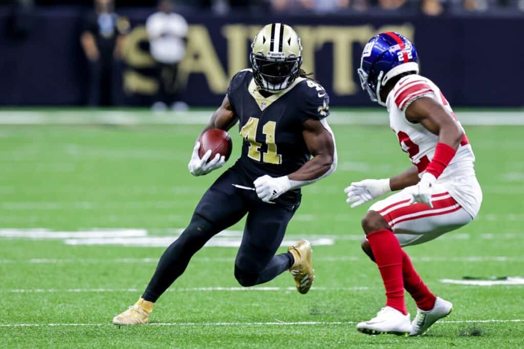 New Orleans Saints running back running the football past a New York Giants player. Cowboys 2025 Rookie Drawing Comparisons to Big Time Players