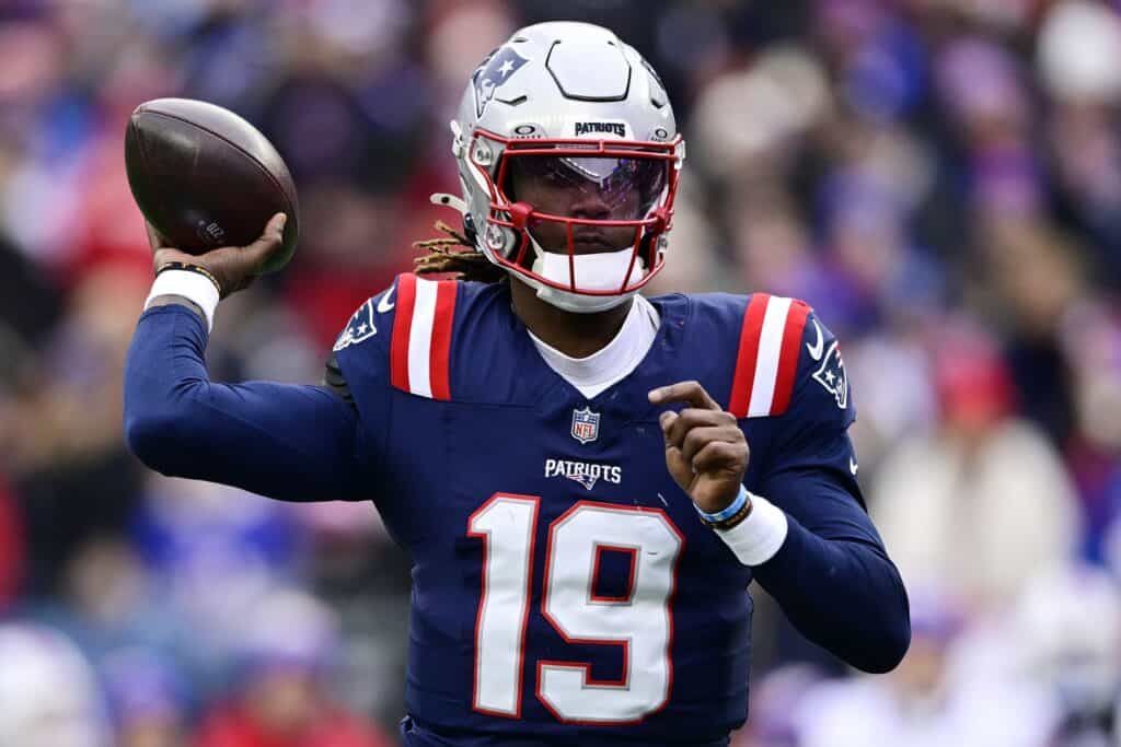 Dallas Cowboys quarterback Milton in a New England Patriots uniform throwing the football. Joe Milton is What the Cowboys Thought Trey Lance Would Be