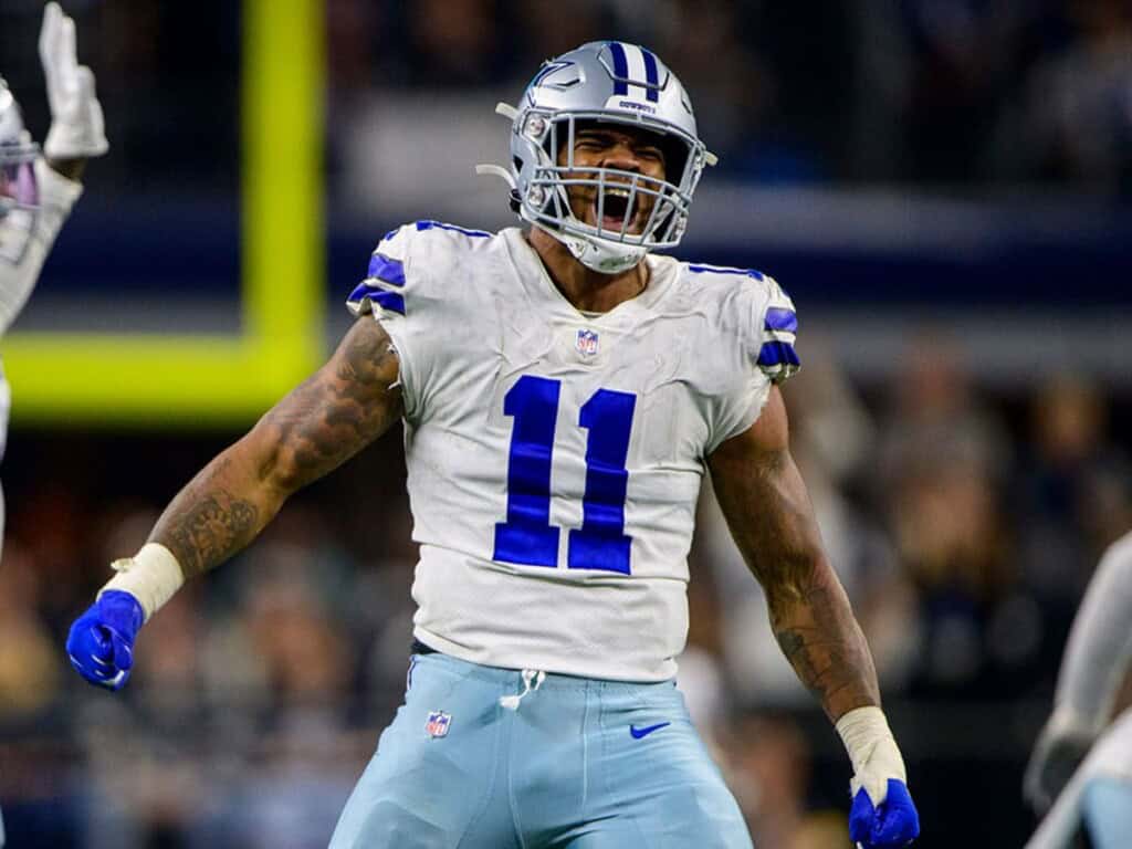Dallas Cowboys Micah Parsons, wearing the white Dallas Cowboys uniform with the number 11 in blue on the chest, screaming after a big play. 5 Explosive Reasons Micah Parsons Owns the NFL